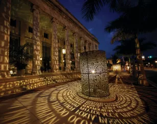 manuscripts sculpture at sidney berne davis art center lit up at night
