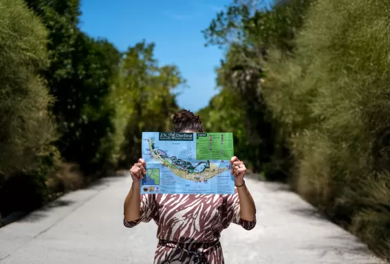 Woman holding map of J.N. "Ding" Darling National Wildlife Refuge