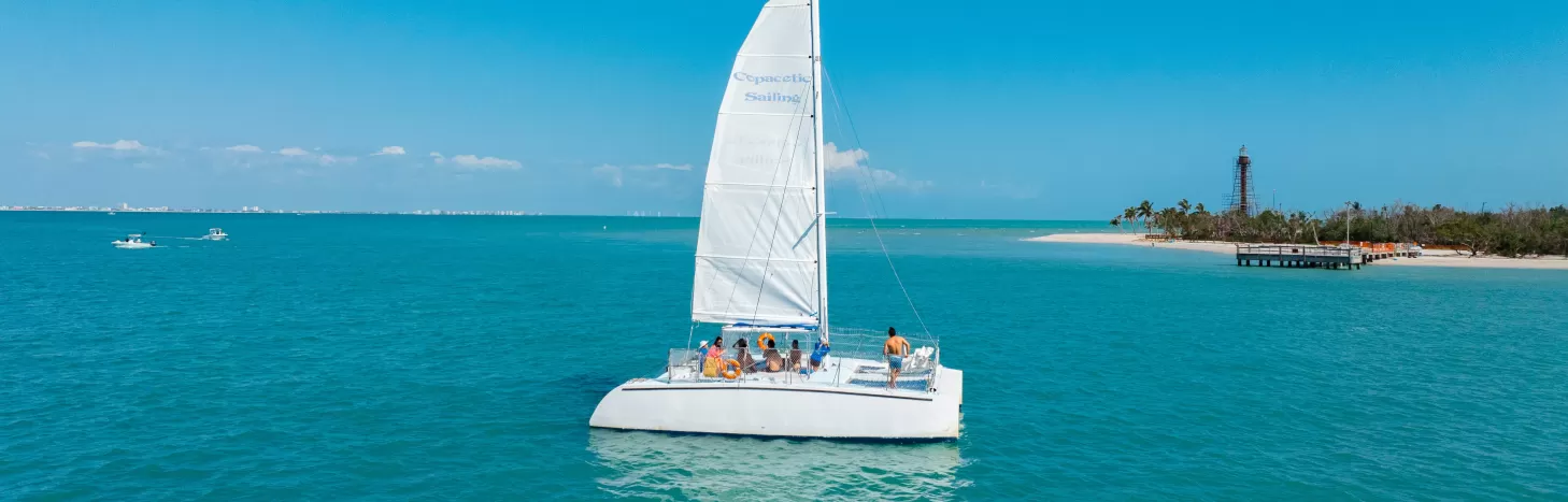 A small sailboat in the middle of a large body of water